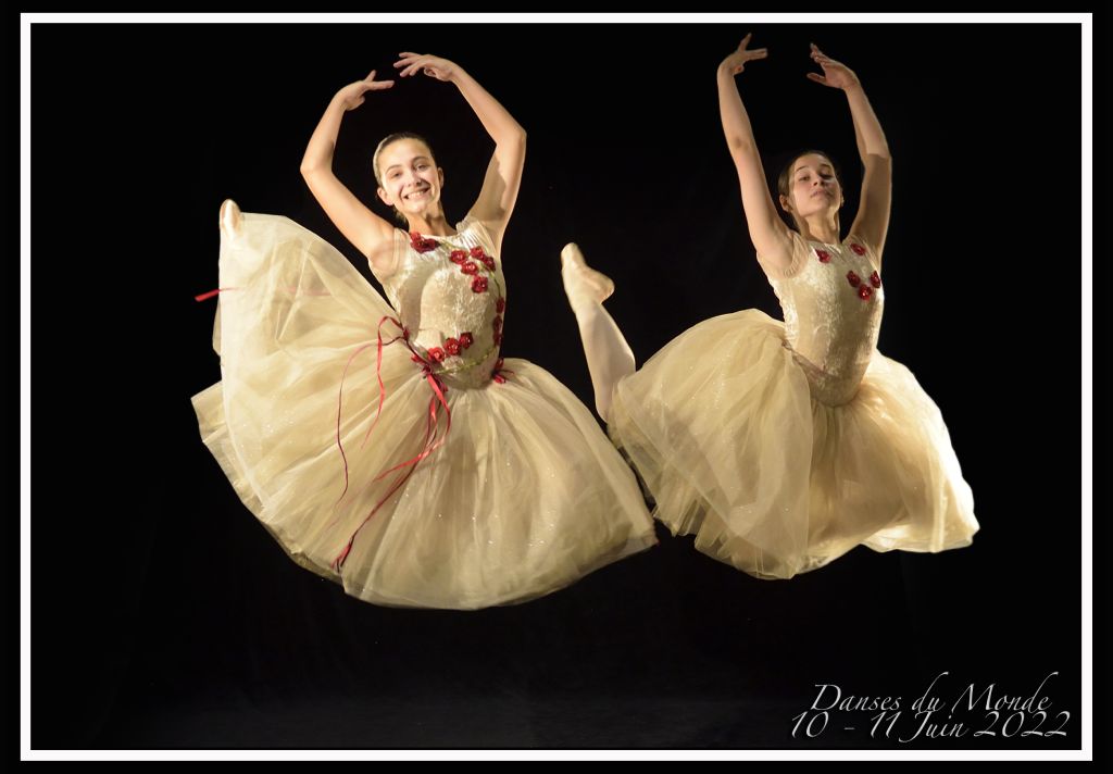 Duo de danseuses classiques en saut, costumes ivoire et roses rouges